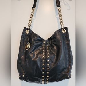 Micheal Kors leather bag with gold chain and rivets.